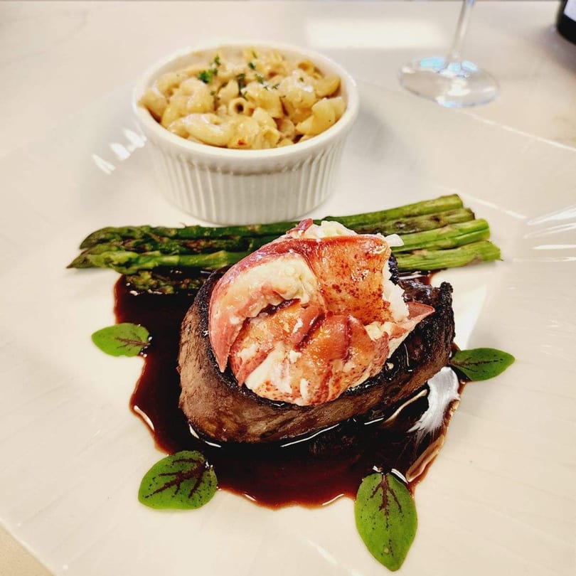 El Camaron Italiano's surf and turf with lobster, steak, asparagus, and mac and cheese.